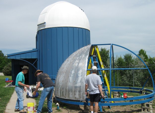 Rivet crew skins the frame of the new dome